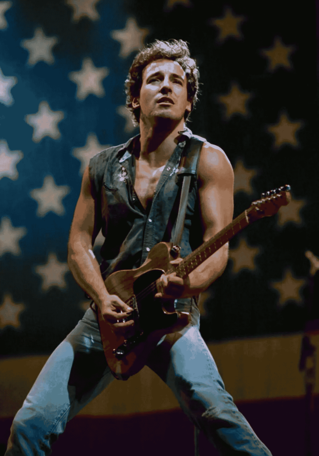 Bruce Springsteen gitárral, csillagos színpadi háttér előtt